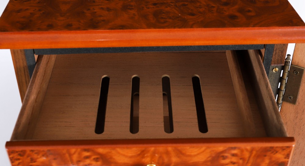 A square burr elm cigar humidor cabinet featuring a glass viewing window, brass hygrometer, front lock, and polished wood figure. View VIII
