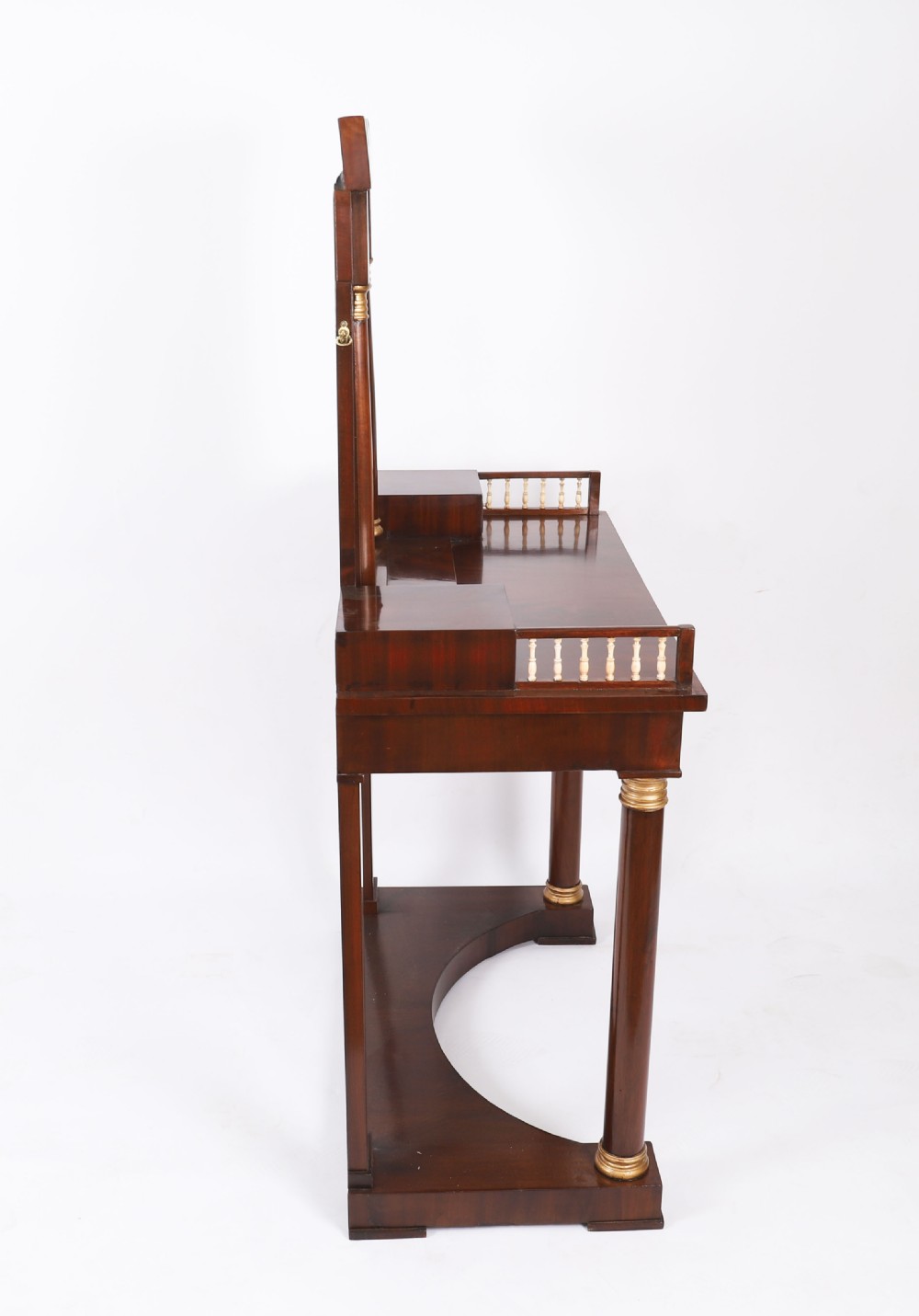 A 19th-century French Empire mahogany dressing table with a central adjustable mirror, gilded column supports, small side drawers, and a lower curved stretcher. View VI