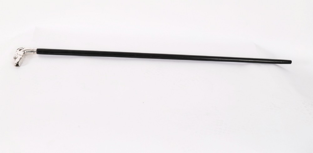 A 19th-century French walking stick featuring a black ebonised shaft and a silver handle sculpted in the shape of a greyhound head.