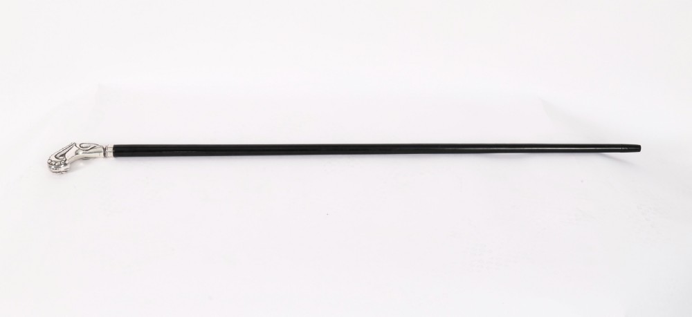 An antique French Art Nouveau walking cane featuring an ornate silver handle and a tapered black wooden shaft.