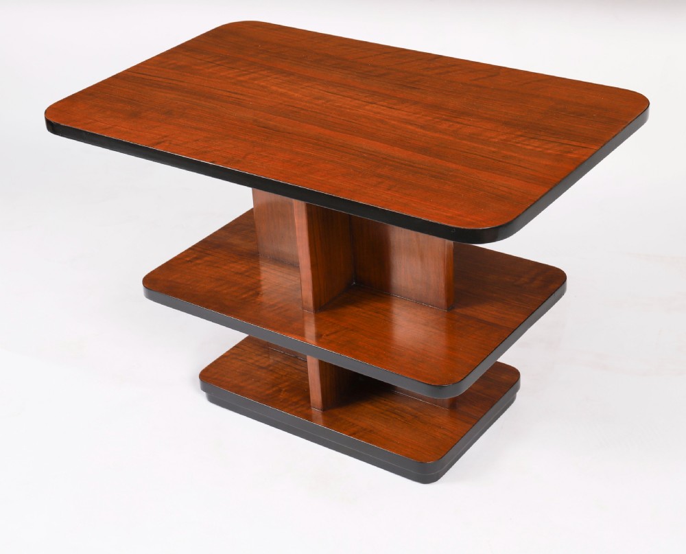 An antique Art Deco tiered walnut coffee table featuring rounded rectangular surfaces, central vertical dividers, and dark ebonised trim on a plain background. View III