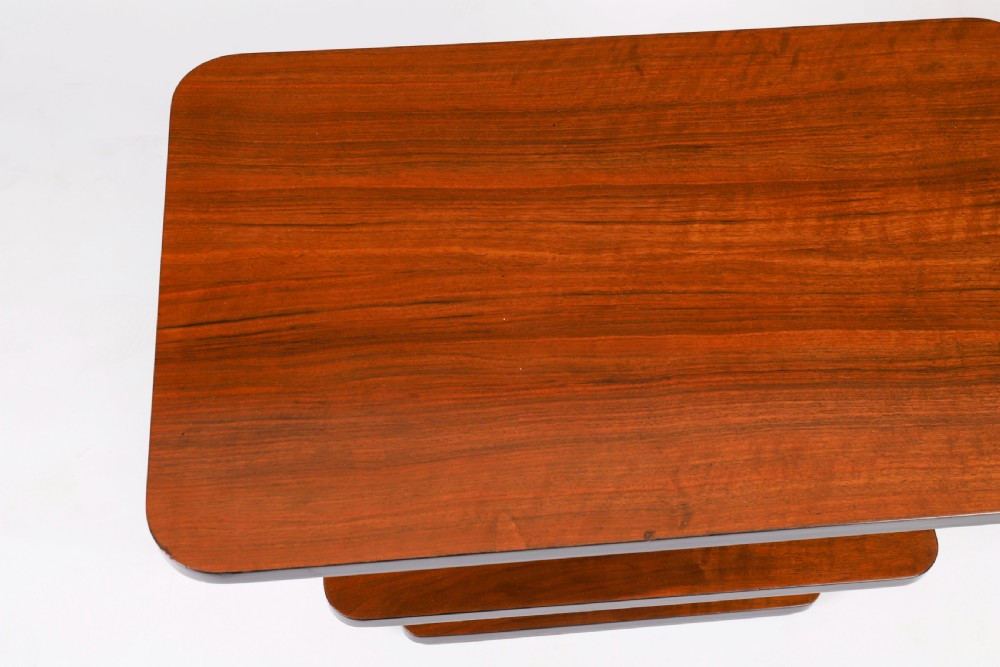 An antique Art Deco tiered walnut coffee table featuring rounded rectangular surfaces, central vertical dividers, and dark ebonised trim on a plain background. View VII