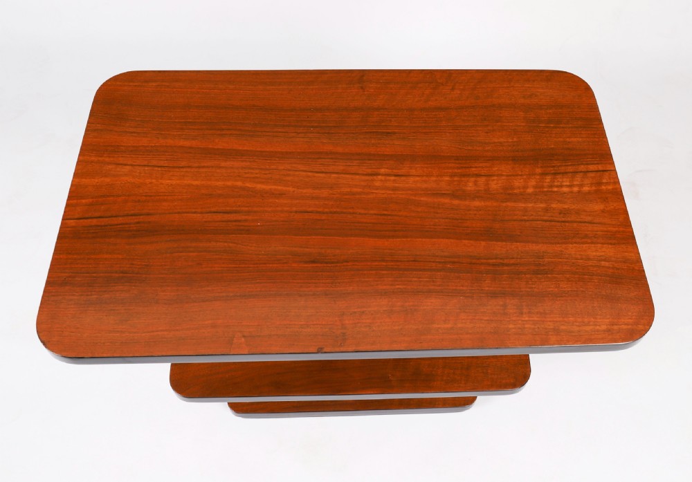 An antique Art Deco tiered walnut coffee table featuring rounded rectangular surfaces, central vertical dividers, and dark ebonised trim on a plain background. View VIII