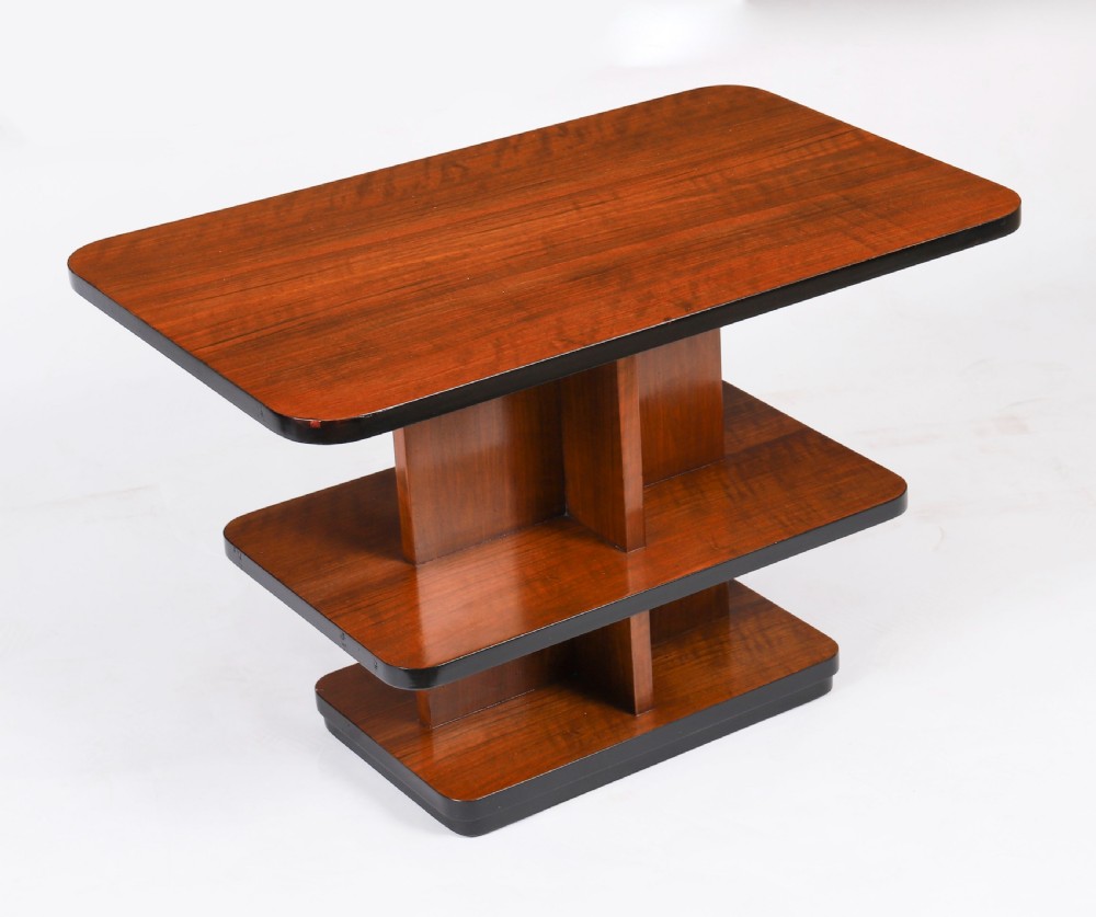 An antique Art Deco tiered walnut coffee table featuring rounded rectangular surfaces, central vertical dividers, and dark ebonised trim on a plain background. View XII