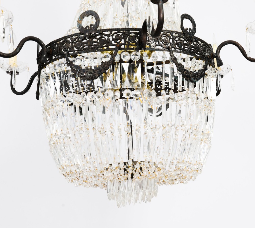 A large 1920s Louis Revival tent chandelier featuring an upper cone and lower basket of cut crystal beads set on a patinated bronze band with fourteen radiating candle arms. View IV