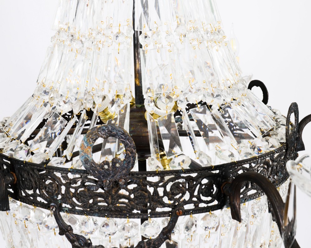 A large 1920s Louis Revival tent chandelier featuring an upper cone and lower basket of cut crystal beads set on a patinated bronze band with fourteen radiating candle arms. View VI