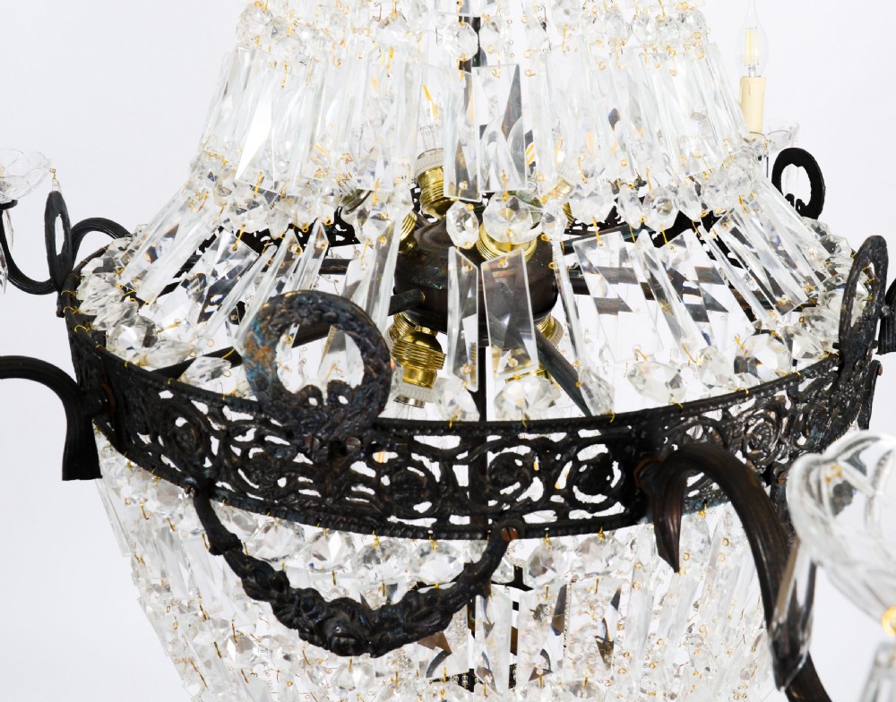A large 1920s Louis Revival tent chandelier featuring an upper cone and lower basket of cut crystal beads set on a patinated bronze band with fourteen radiating candle arms. View VIII