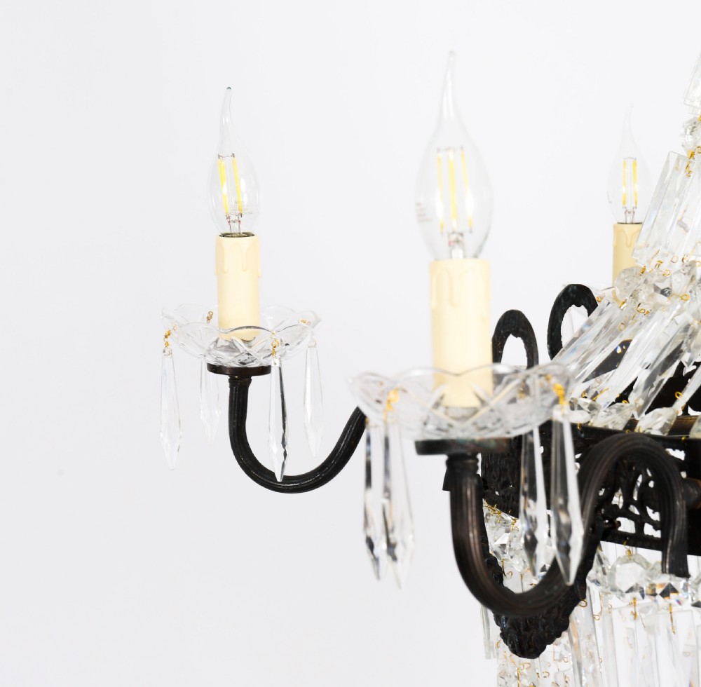 A large 1920s Louis Revival tent chandelier featuring an upper cone and lower basket of cut crystal beads set on a patinated bronze band with fourteen radiating candle arms. View XIII