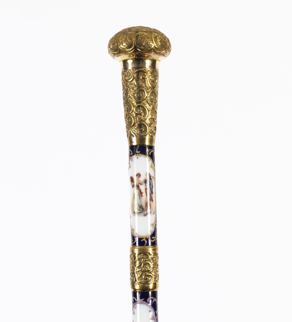 A 19th-century French walking stick featuring a dark wood shaft and a gold-plated pommel adorned with painted porcelain inserts. View XVII