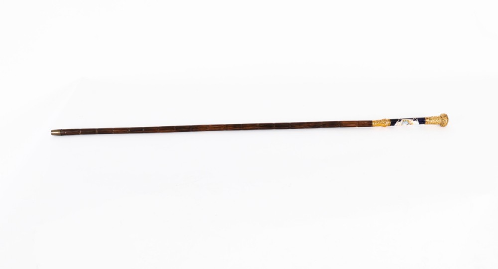 A nineteenth-century French walking cane featuring a dark wooden shaft, a concealed steel blade, and a gilt metal handle mounted with painted Sevres porcelain. View VIII