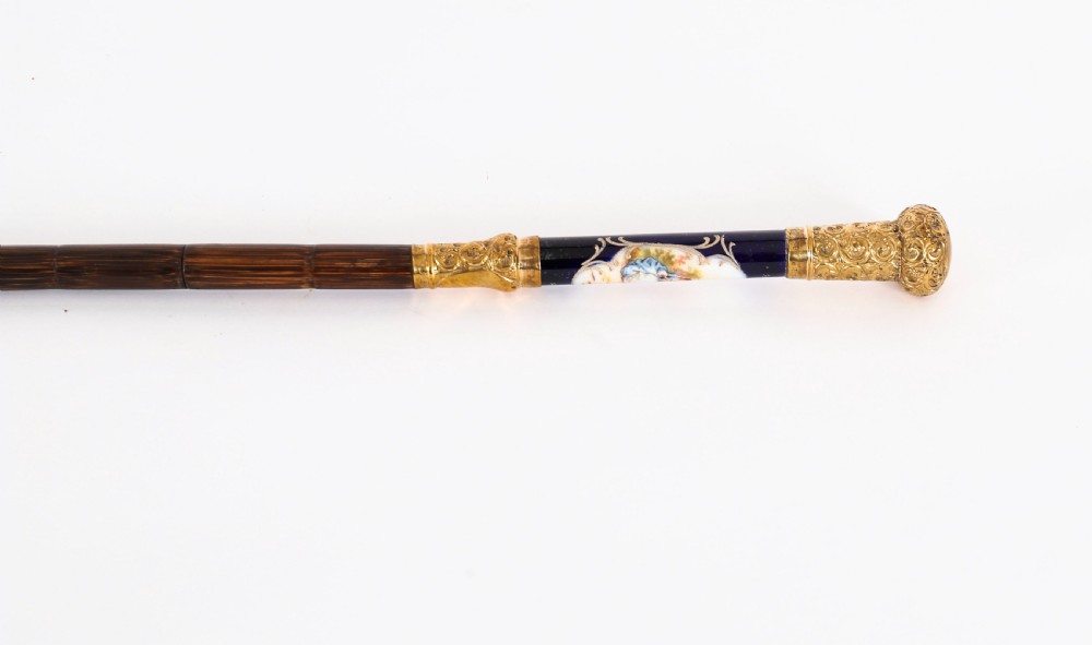 A nineteenth-century French walking cane featuring a dark wooden shaft, a concealed steel blade, and a gilt metal handle mounted with painted Sevres porcelain. View XII