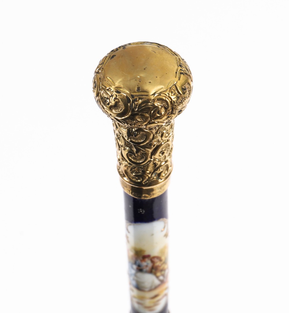 A nineteenth-century French walking cane featuring a dark wooden shaft, a concealed steel blade, and a gilt metal handle mounted with painted Sevres porcelain. View XVI