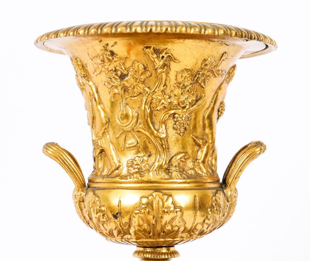 A pair of 19th-century French Grand Tour gilt bronze campana urns featuring classical figure reliefs, mounted on square green marble pedestal bases with gilt laurel wreaths. View IV