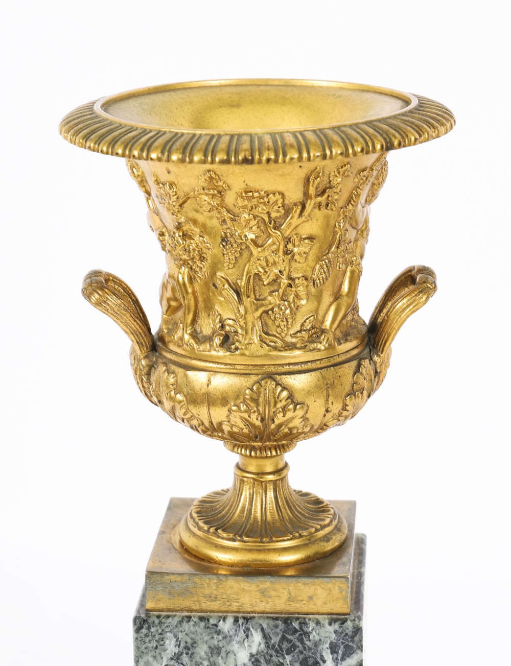 A pair of 19th-century French Grand Tour gilt bronze campana urns featuring classical figure reliefs, mounted on square green marble pedestal bases with gilt laurel wreaths. View VI