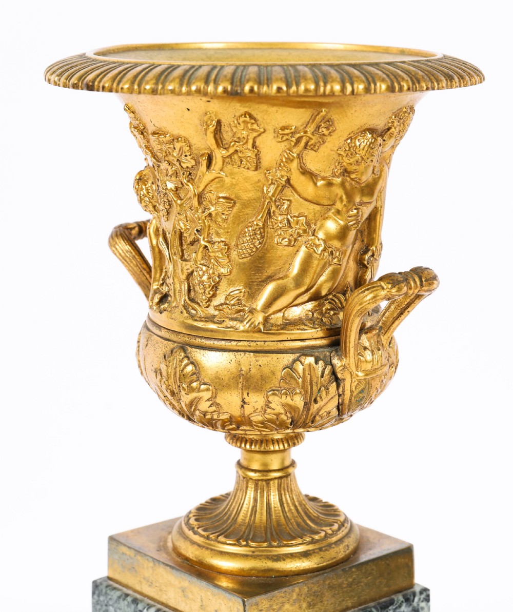 A pair of 19th-century French Grand Tour gilt bronze campana urns featuring classical figure reliefs, mounted on square green marble pedestal bases with gilt laurel wreaths. View XV