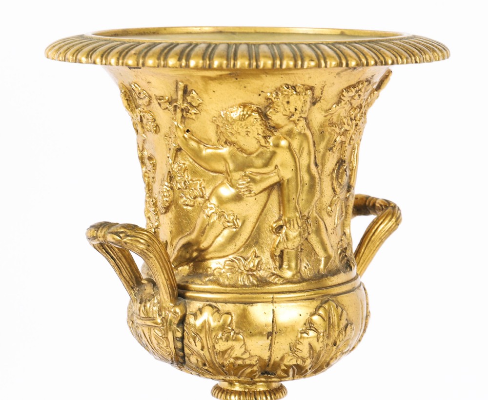 A pair of 19th-century French Grand Tour gilt bronze campana urns featuring classical figure reliefs, mounted on square green marble pedestal bases with gilt laurel wreaths. View XVII