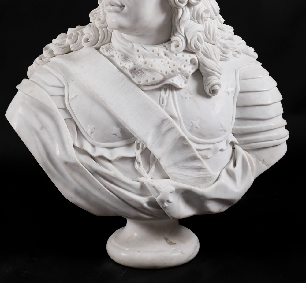 Carved white marble bust depicting a nobleman with long curled hair, lace cravat, and plate armour on a turned circular pedestal. View XIV