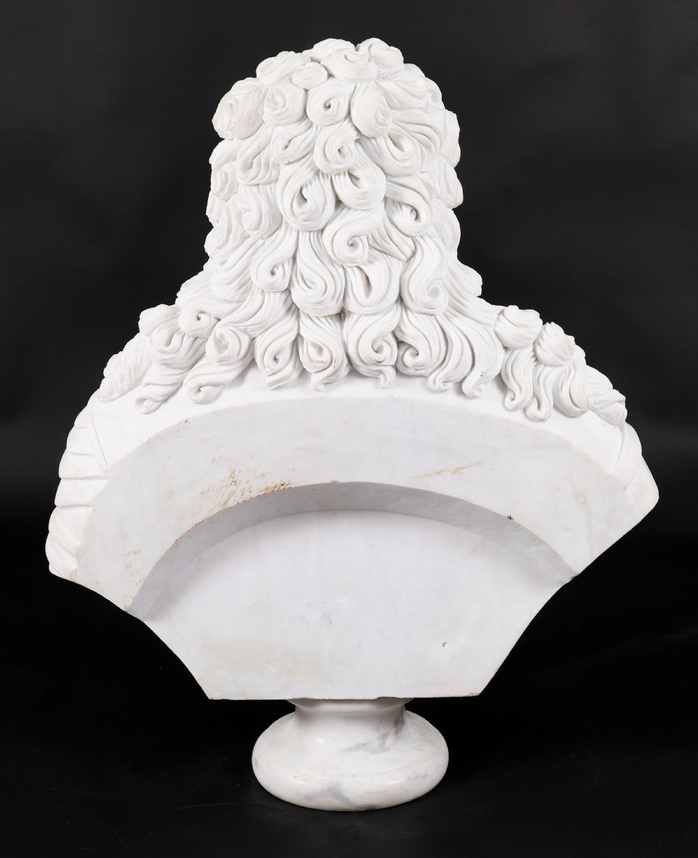 Carved white marble bust depicting a nobleman with long curled hair, lace cravat, and plate armour on a turned circular pedestal. View XVIII