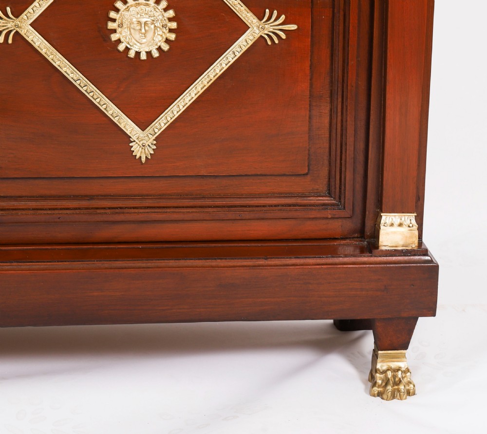 A nineteenth-century French Empire Revival mahogany bookcase featuring twin glazed doors, gilt bronze mounts, a marble top, and metal paw feet. View IX