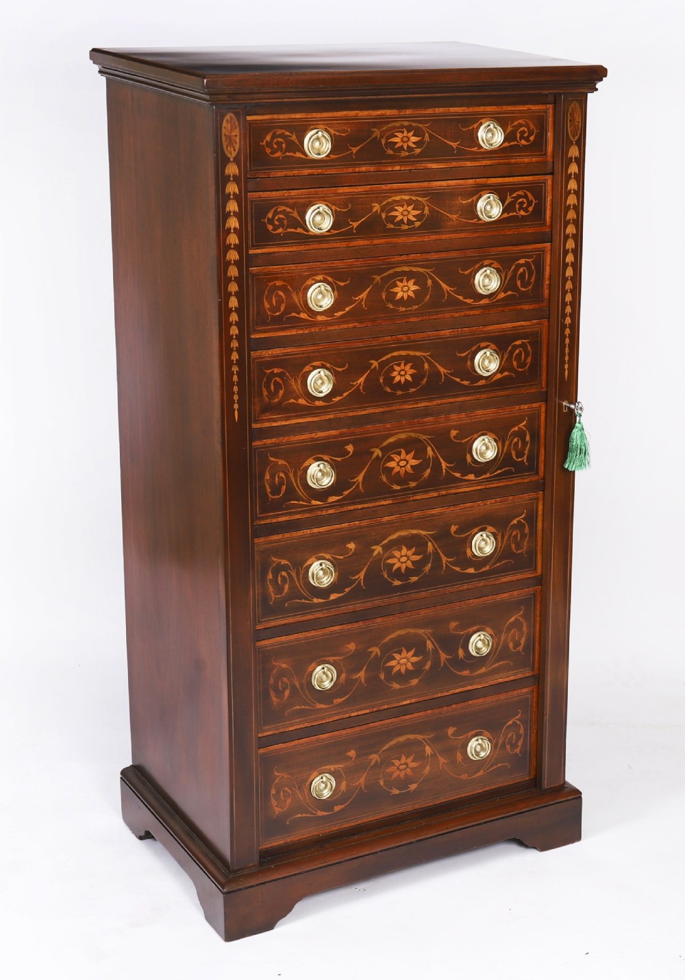 An Edwardian mahogany Wellington chest featuring eight inlaid drawers, satinwood floral motifs, a right-side locking stile, and brass handles.