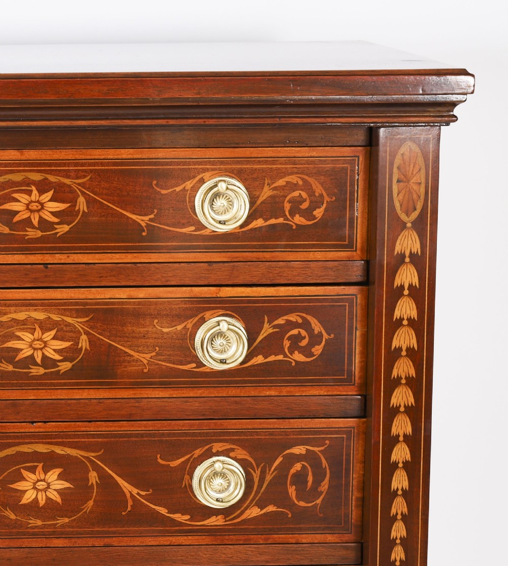 An Edwardian mahogany Wellington chest featuring eight inlaid drawers, satinwood floral motifs, a right-side locking stile, and brass handles. View III