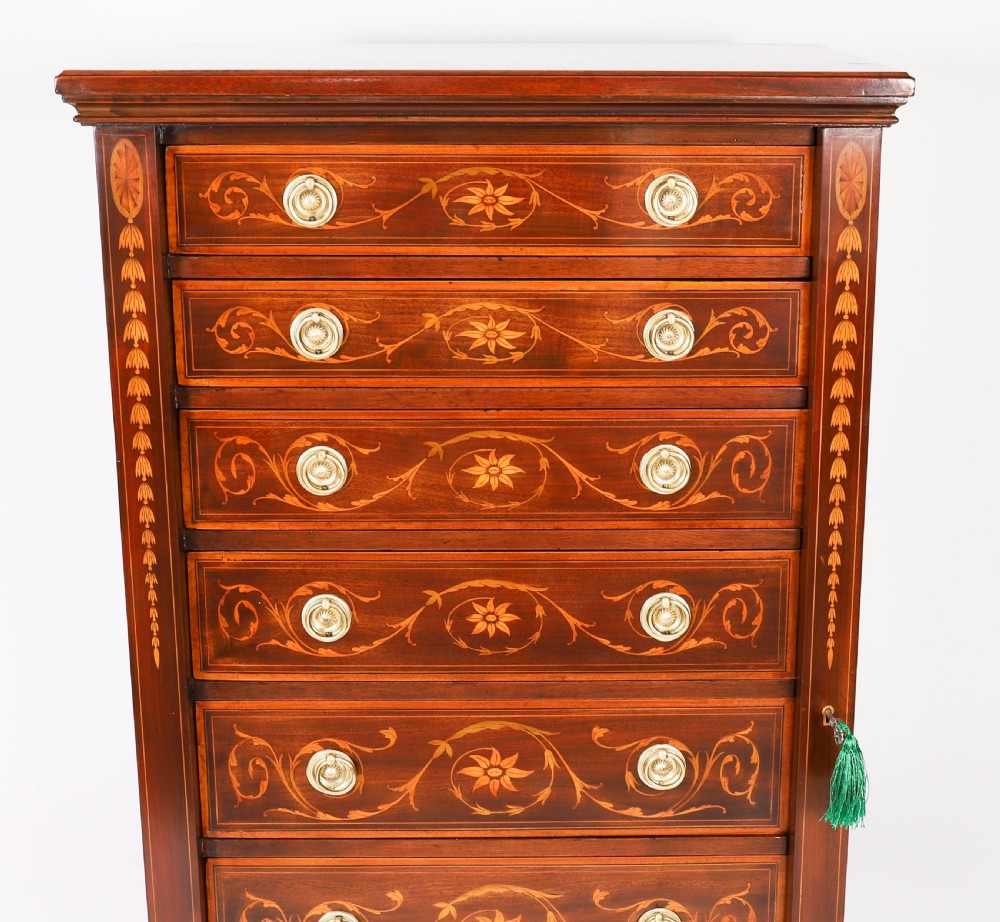 An Edwardian mahogany Wellington chest featuring eight inlaid drawers, satinwood floral motifs, a right-side locking stile, and brass handles. View IV