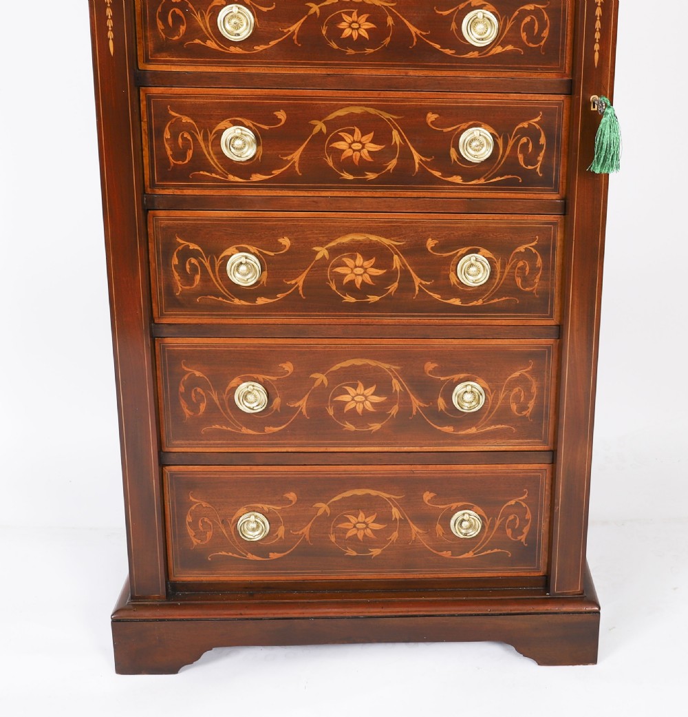 An Edwardian mahogany Wellington chest featuring eight inlaid drawers, satinwood floral motifs, a right-side locking stile, and brass handles. View VI