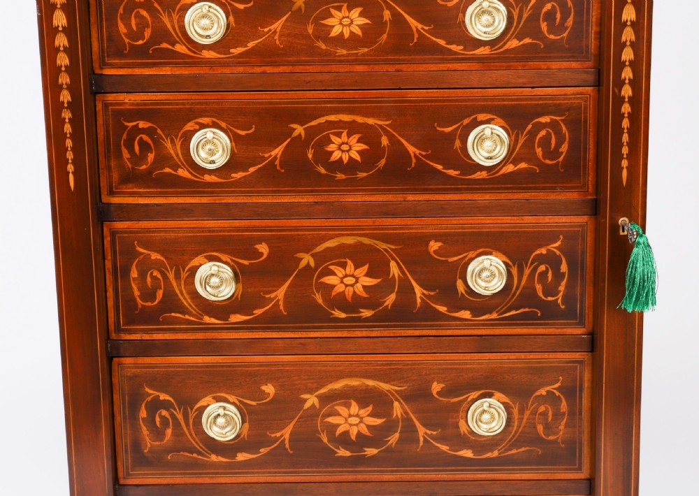 An Edwardian mahogany Wellington chest featuring eight inlaid drawers, satinwood floral motifs, a right-side locking stile, and brass handles. View VIII