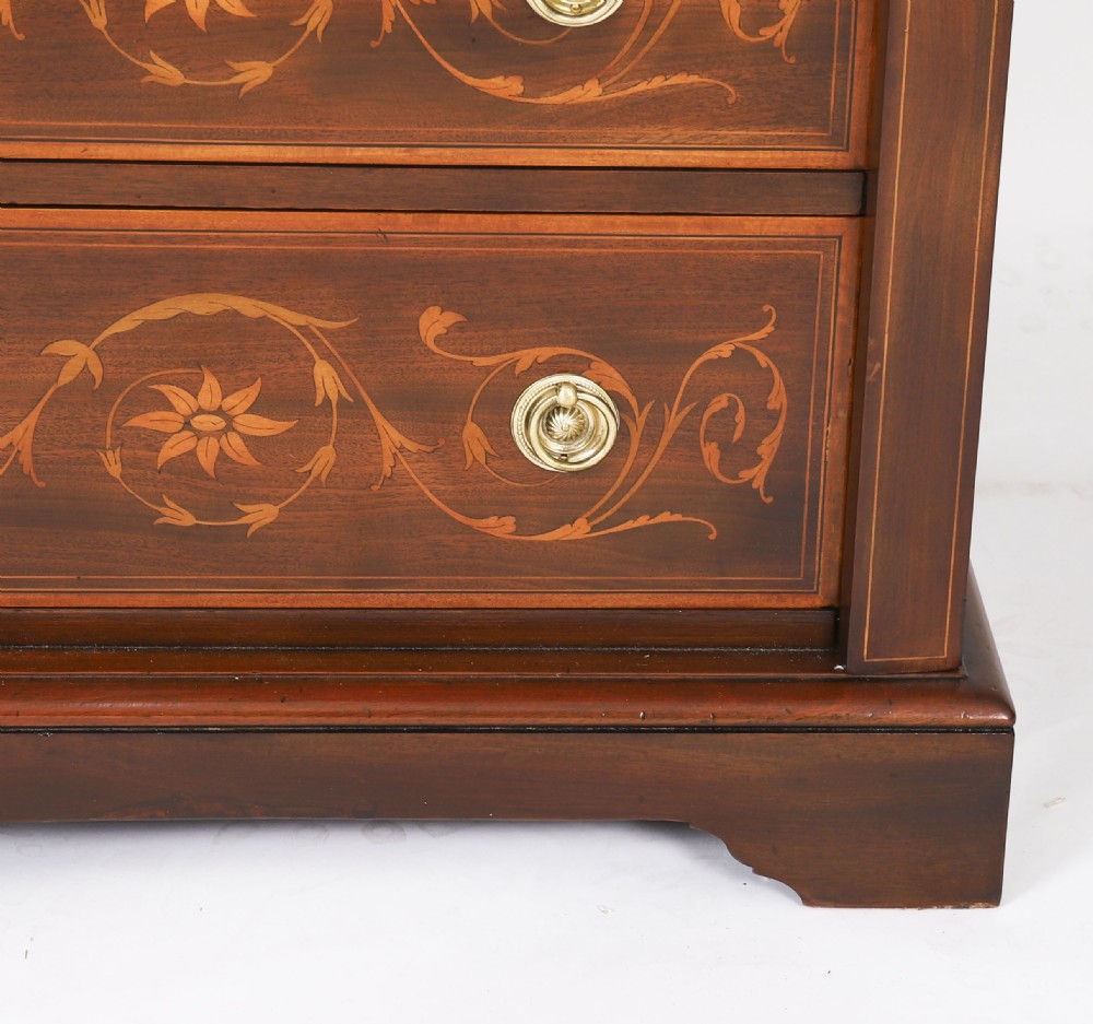 An Edwardian mahogany Wellington chest featuring eight inlaid drawers, satinwood floral motifs, a right-side locking stile, and brass handles. View X