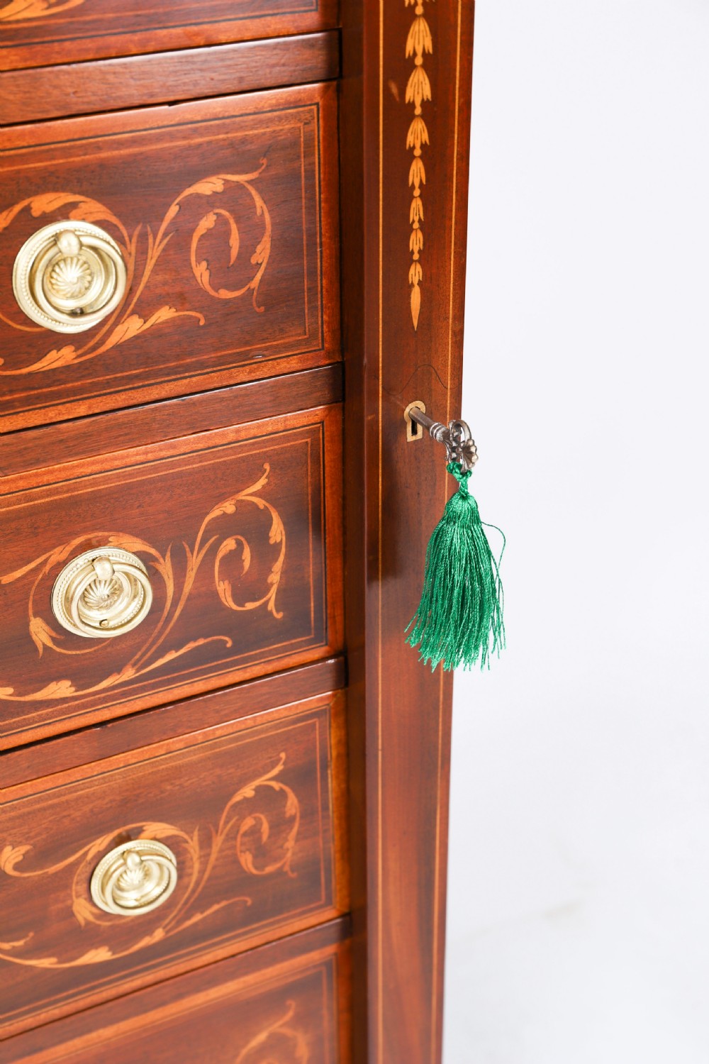 An Edwardian mahogany Wellington chest featuring eight inlaid drawers, satinwood floral motifs, a right-side locking stile, and brass handles. View XI