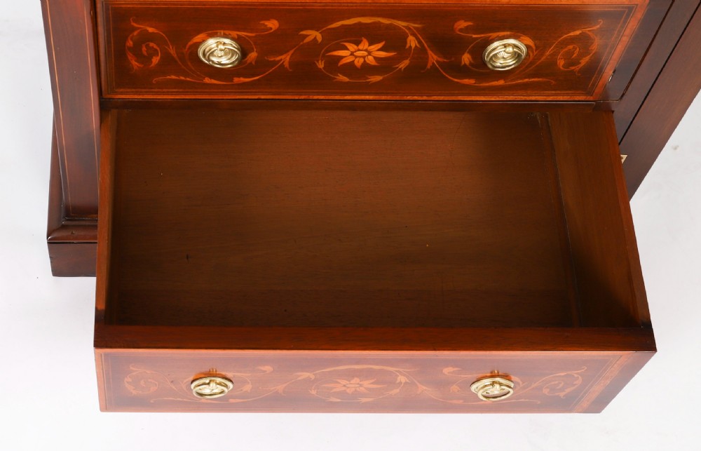 An Edwardian mahogany Wellington chest featuring eight inlaid drawers, satinwood floral motifs, a right-side locking stile, and brass handles. View XIV