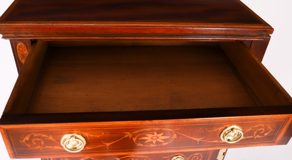 An Edwardian mahogany Wellington chest featuring eight inlaid drawers, satinwood floral motifs, a right-side locking stile, and brass handles. View XV