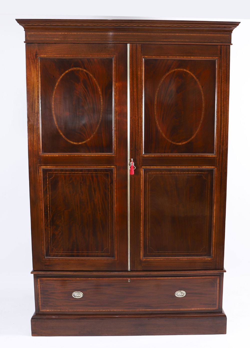 A late 19th-century George III revival flame mahogany double wardrobe featuring oval panel inlays, twin doors, a single bottom drawer, and a moulded cornice. View VIII