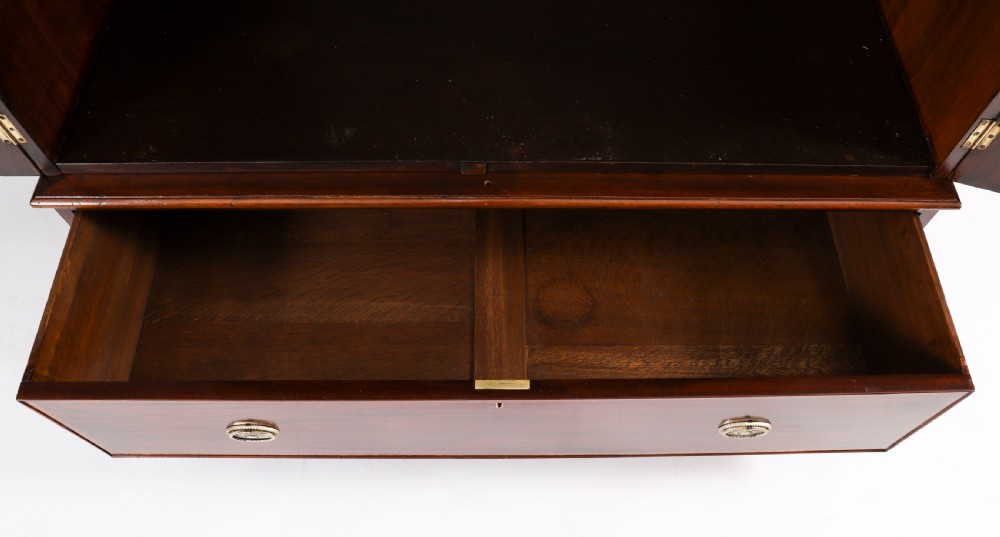 A late 19th-century George III revival flame mahogany double wardrobe featuring oval panel inlays, twin doors, a single bottom drawer, and a moulded cornice. View XV