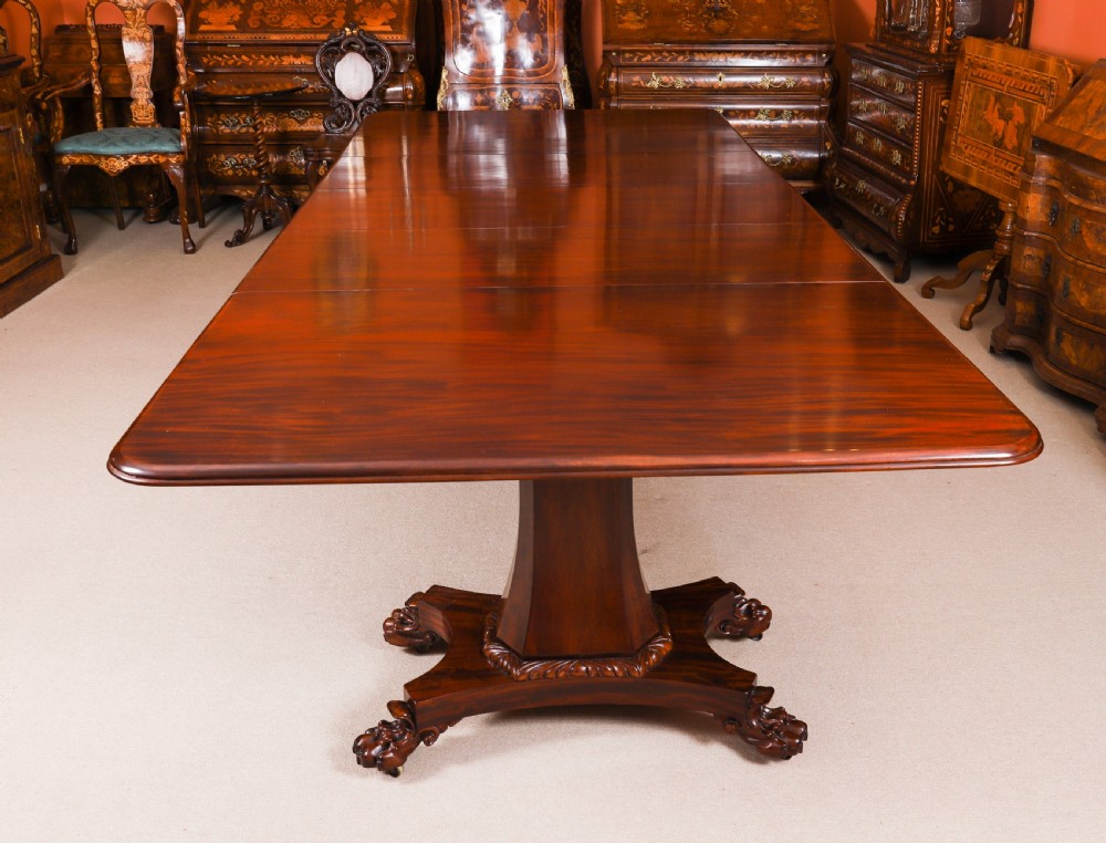 An extendable George IV Regency mahogany twin pedestal dining table with carved paw feet. View II