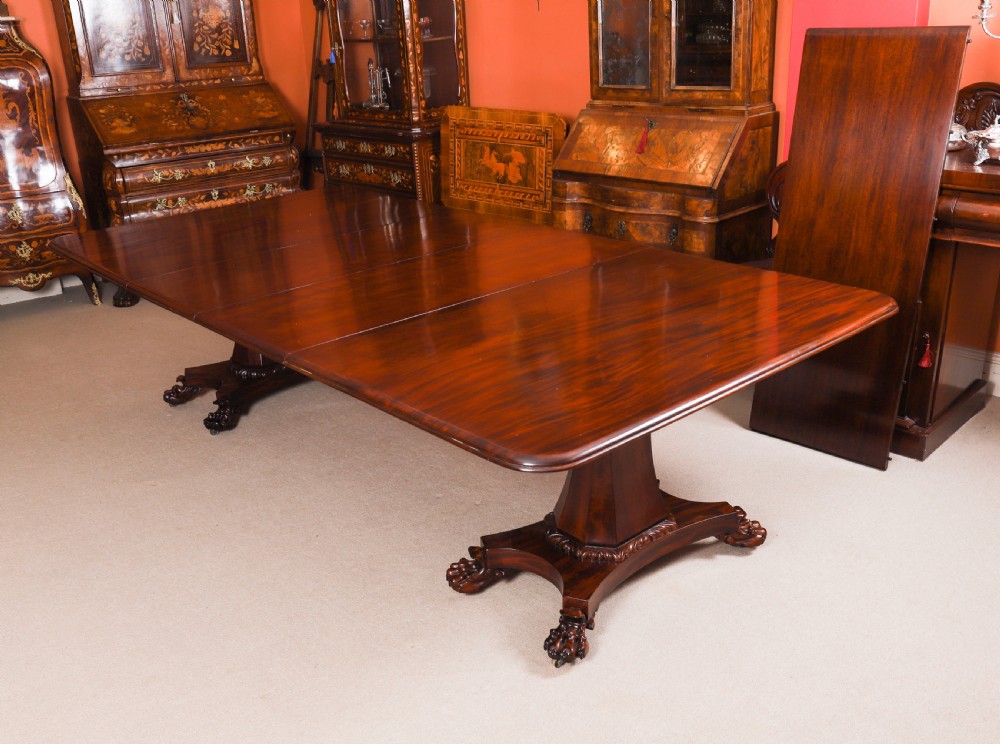 An extendable George IV Regency mahogany twin pedestal dining table with carved paw feet. View VI
