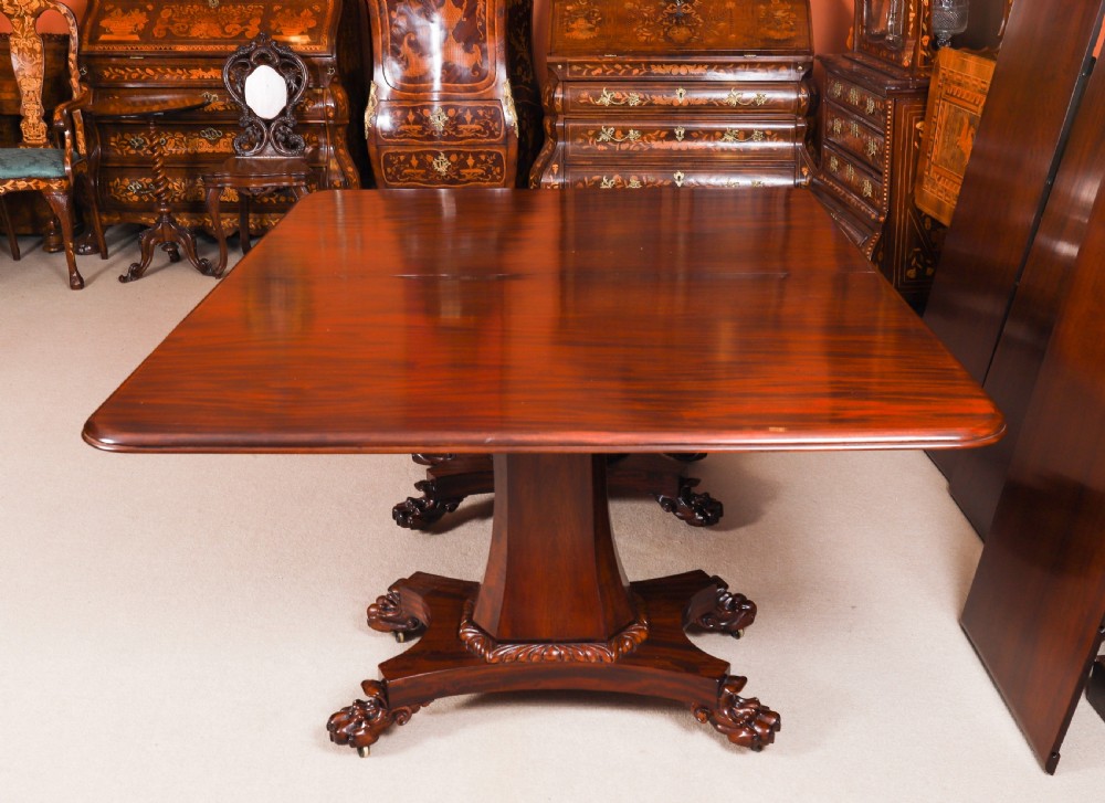 An extendable George IV Regency mahogany twin pedestal dining table with carved paw feet. View IX