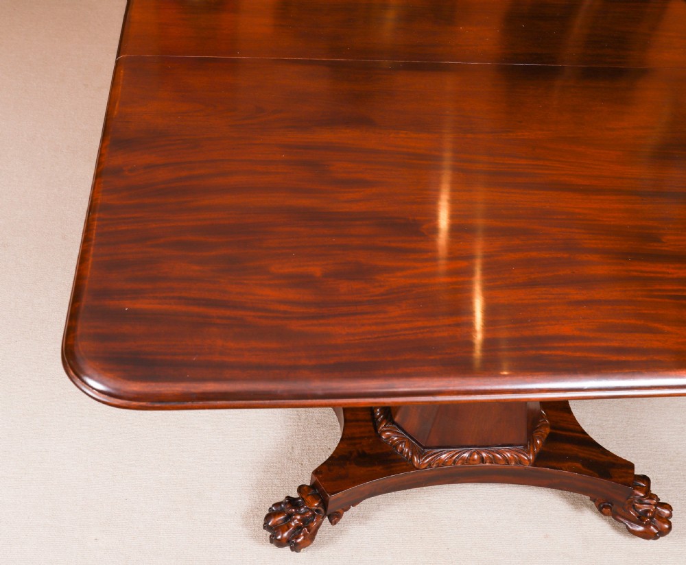 An extendable George IV Regency mahogany twin pedestal dining table with carved paw feet. View X