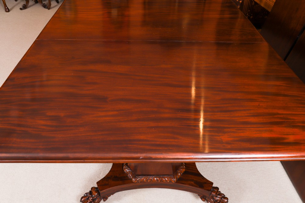 An extendable George IV Regency mahogany twin pedestal dining table with carved paw feet. View XI