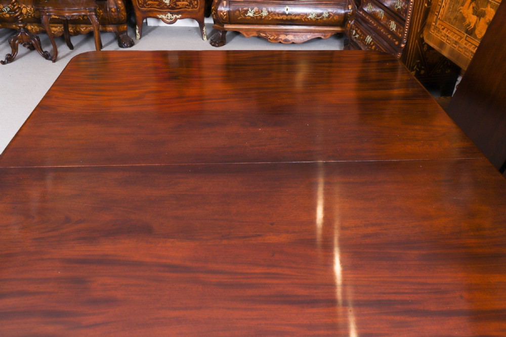 An extendable George IV Regency mahogany twin pedestal dining table with carved paw feet. View XII
