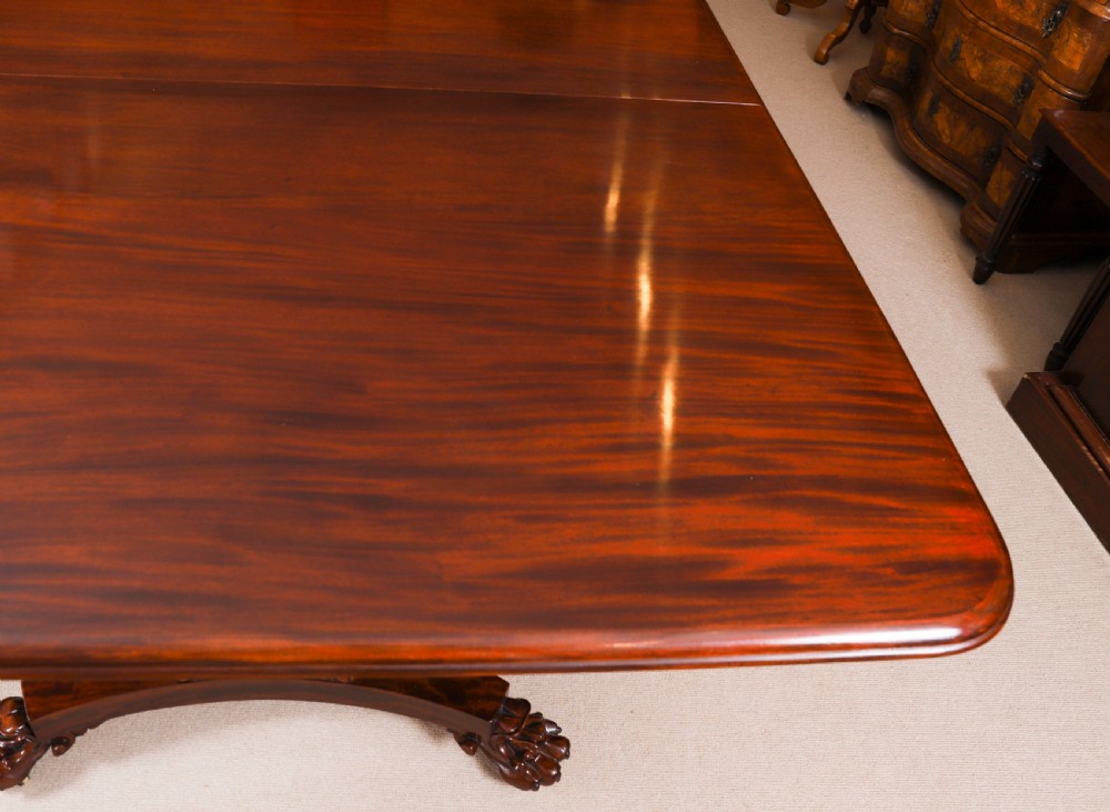 An extendable George IV Regency mahogany twin pedestal dining table with carved paw feet. View XV