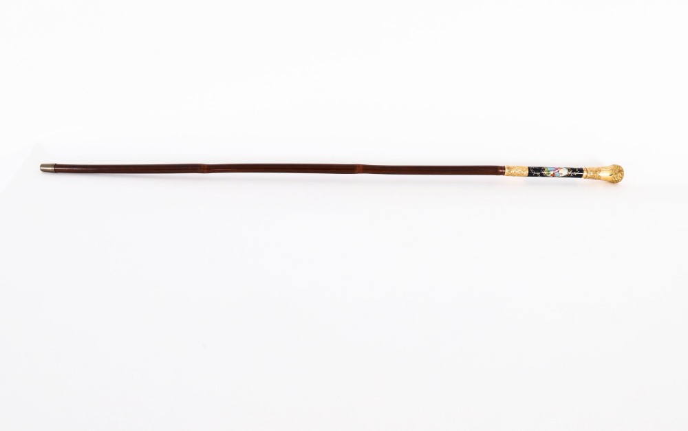A 19th-century French sword stick featuring a chased gold-plated pommel and a hand-painted Sevres style cobalt blue porcelain collar above a wooden shaft with a partially drawn steel blade. View V