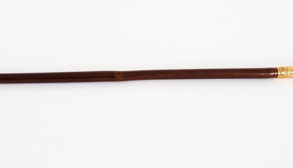 A 19th-century French sword stick featuring a chased gold-plated pommel and a hand-painted Sevres style cobalt blue porcelain collar above a wooden shaft with a partially drawn steel blade. View VII