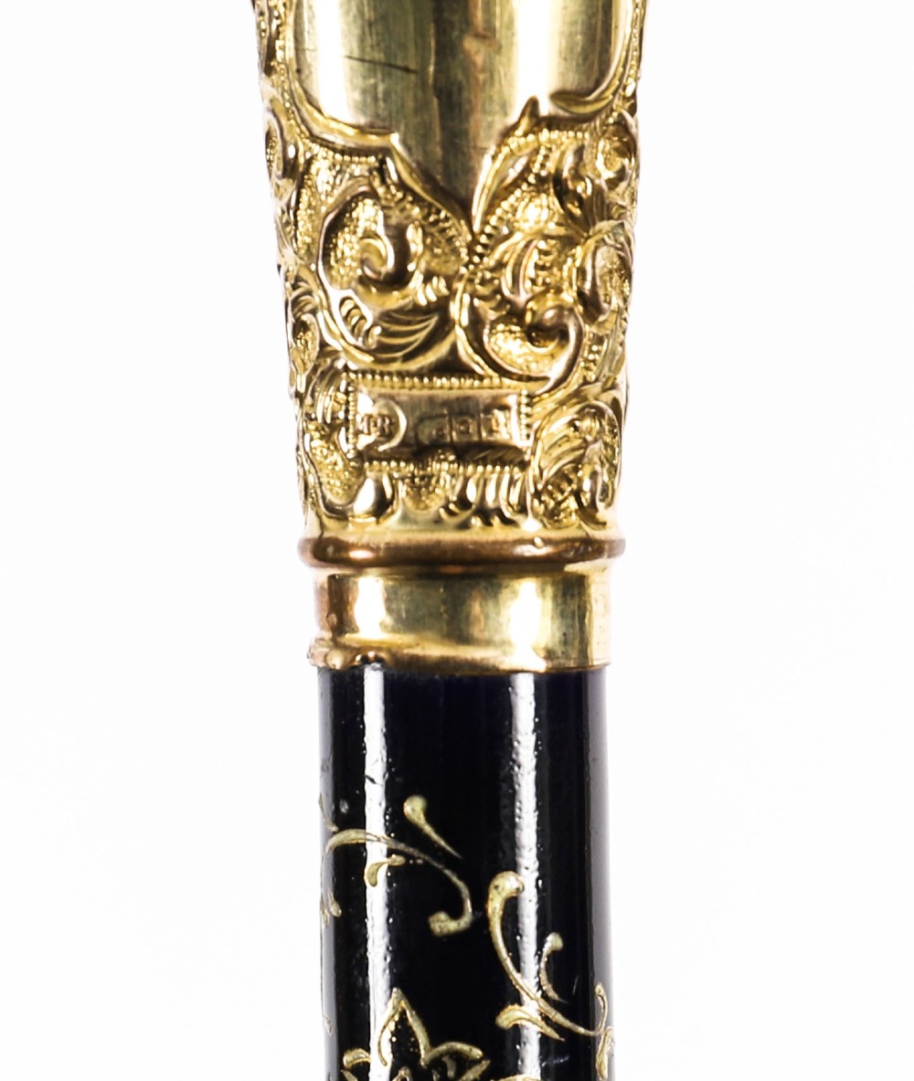 A 19th-century French sword stick featuring a chased gold-plated pommel and a hand-painted Sevres style cobalt blue porcelain collar above a wooden shaft with a partially drawn steel blade. View XV