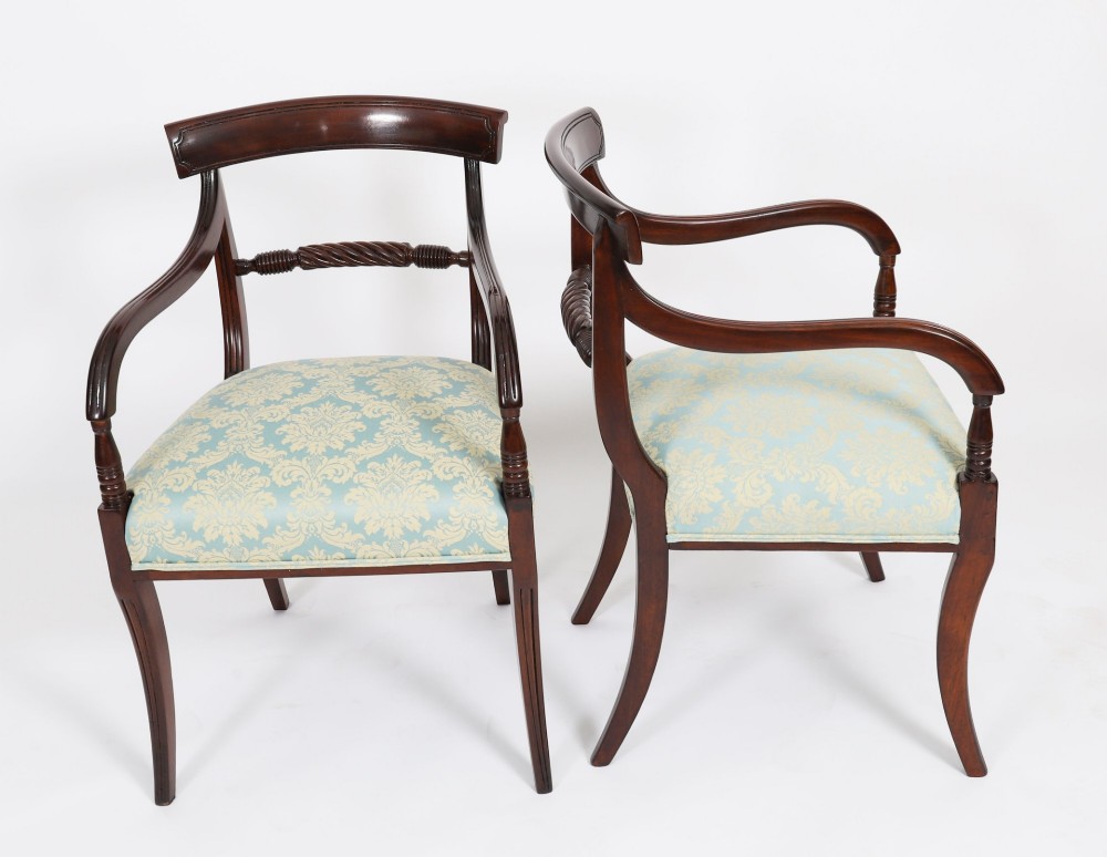 A set of eight Regency mahogany dining chairs, including two carvers, featuring curved top rails, rope-twist splats, and pale blue patterned upholstered seats. View II