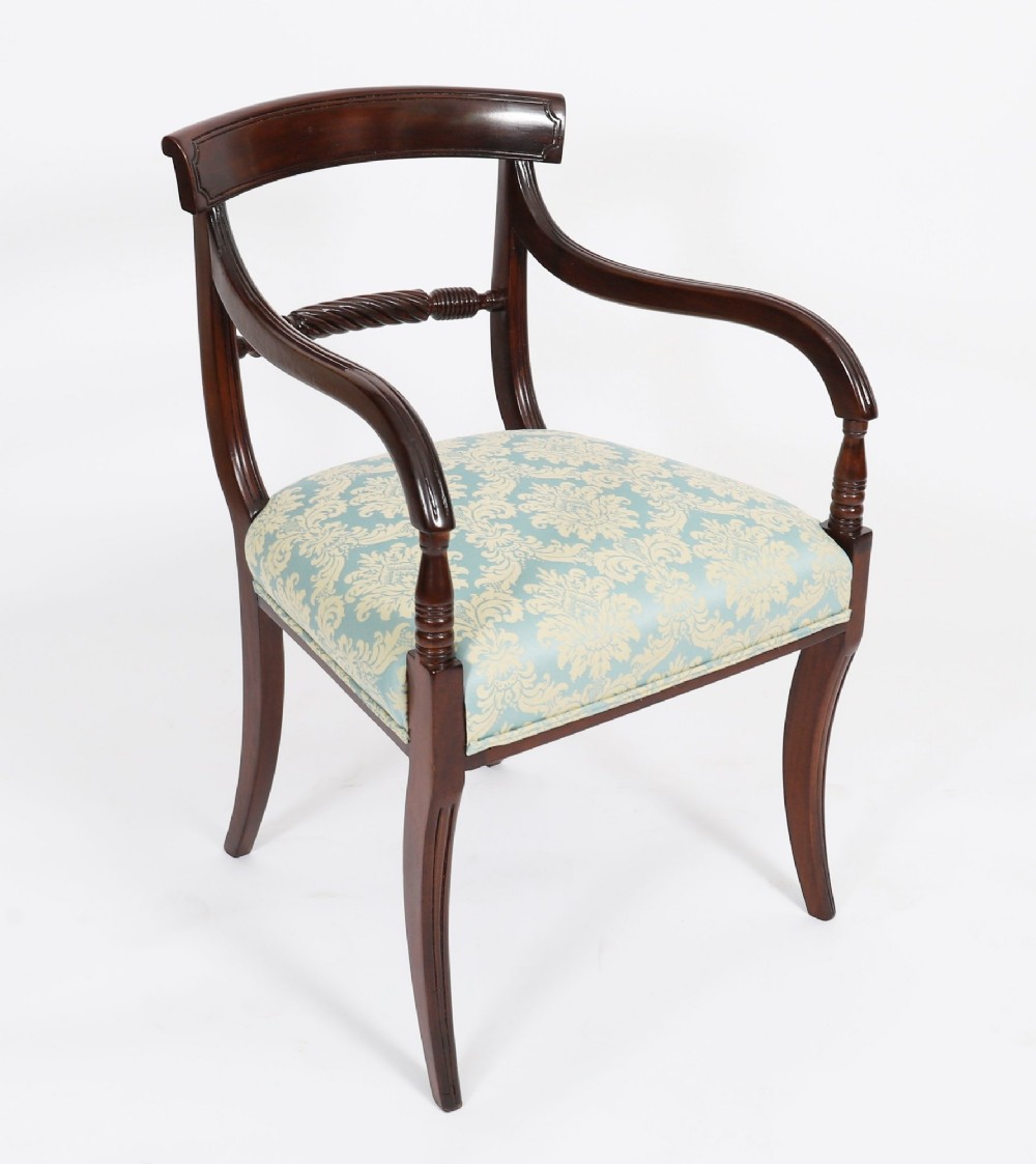 A set of eight Regency mahogany dining chairs, including two carvers, featuring curved top rails, rope-twist splats, and pale blue patterned upholstered seats. View III
