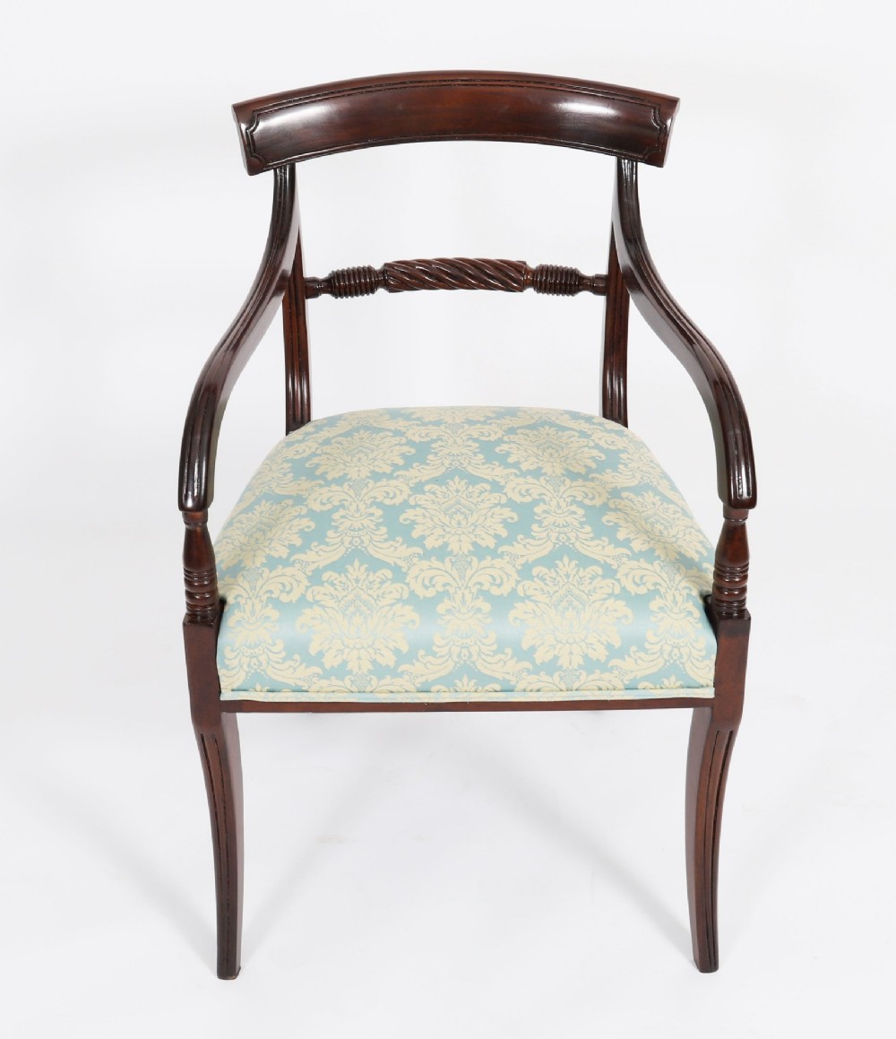 A set of eight Regency mahogany dining chairs, including two carvers, featuring curved top rails, rope-twist splats, and pale blue patterned upholstered seats. View IV