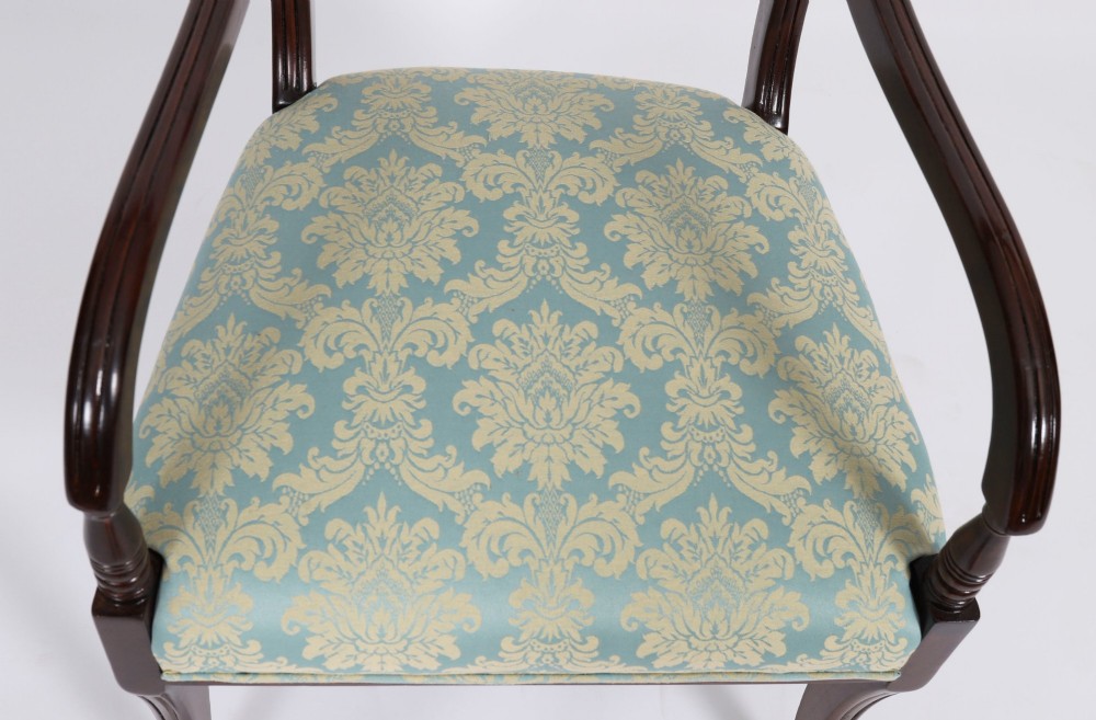 A set of eight Regency mahogany dining chairs, including two carvers, featuring curved top rails, rope-twist splats, and pale blue patterned upholstered seats. View VII