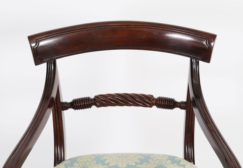 A set of eight Regency mahogany dining chairs, including two carvers, featuring curved top rails, rope-twist splats, and pale blue patterned upholstered seats. View IX