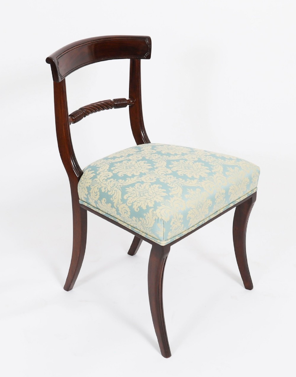 A set of eight Regency mahogany dining chairs, including two carvers, featuring curved top rails, rope-twist splats, and pale blue patterned upholstered seats. View XII